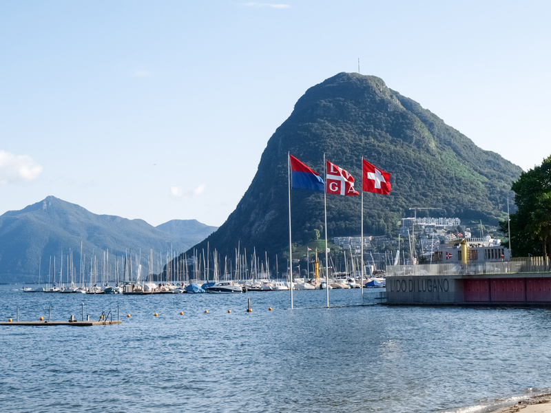 Lake Lugano, Monte San Salvatore ,and the flags of Switzerland,